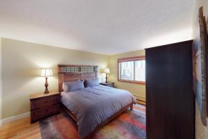 a bedroom with a large bed and a window at Quaint Mountain Condo in Frisco
