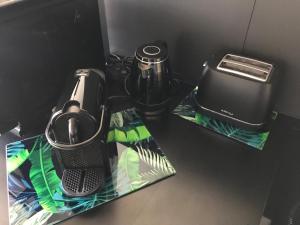 a black counter top with a blender and a toaster at TheGuthPlace in Rouffach