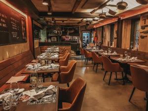 a row of tables and chairs in a restaurant at feRUS Hotel in Lucerne