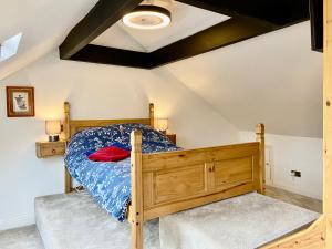 a bedroom with a wooden bed in a room at Garden Villa in Stafford
