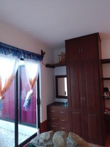 a bedroom with a bed and a dresser and a mirror at El mana de San Francisco in Oaxaca City