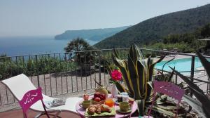 a table with a plate of food on top of a balcony at Oroverde in Bergeggi