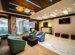 a waiting room with chairs and a screen at LA GRRANDE MALAR in Puducherry