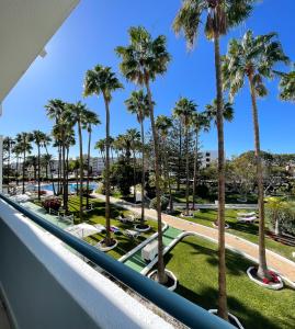 a view from the balcony of a resort with palm trees at Playa Del Sol - Adults Only in Playa del Ingles