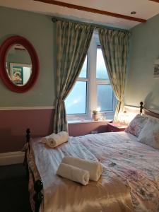 a bedroom with a bed with two towels on it at Longcroft Lodge in Bridlington