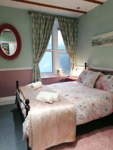 a bedroom with a bed with towels on it at Longcroft Lodge in Bridlington