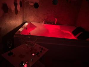 a red hot tub with a table in a room at lapietra_hotelescapes in San Gennaro Vesuviano