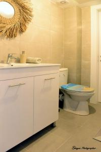 a bathroom with a toilet and a sink at Penthouse Bay View in Eilat