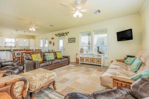 a living room with couches and a dining room at Pelican View in Bolivar Peninsula