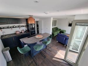a kitchen and living room with a table and chairs at Chy Mor Apartment 1 in St Ives