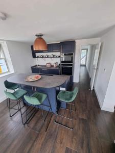 a kitchen with a table and chairs in a room at Chy Mor Apartment 1 in St Ives