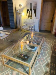 una habitación con una mesa de cristal con velas. en Maison Face au Soleil en Le Bois-Plage-en-Ré