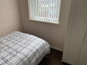 a small bedroom with a bed and a window at Large spacious 3 bedroom house Westerhope in Lemington