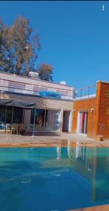 una grande piscina di fronte a un edificio di Villa nahellan a Marrakech