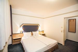 Ein Bett oder Betten in einem Zimmer der Unterkunft Apart' Hotel