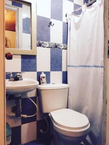 a bathroom with a toilet and a sink at Casa Mamá Waldy New in Cartagena de Indias