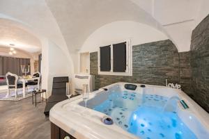 a large bathroom with a blue tub in a room at L'instant Suspendu in La Calmette