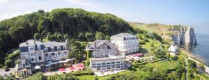 an aerial view of a large building on a hill next to the ocean at Dormy House in Étretat