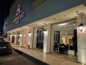 a walmart store with a table and chairs in the front at New MerryLand Hotel in Amman