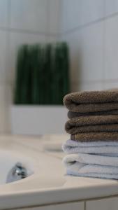 a stack of towels sitting on top of a bathroom sink at Family Ferienhaus Ennens in Rhauderfehn +83 photos
