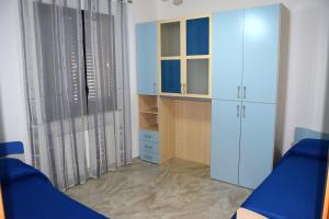 Schlafzimmer mit einem blauen Bett und einem Schrank in der Unterkunft Casa D'Amico in Arnesano