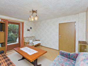 a living room with a couch and a table at Modern Chalet in Piller near Ski Area in Wenns