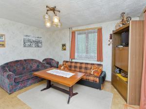 a living room with a couch and a table at Modern Chalet in Piller near Ski Area in Wenns