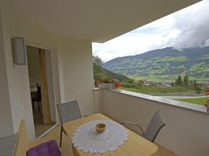 a dining room table with a view of a mountain at Spacious Apartment with Sauna in F gen in Fügen