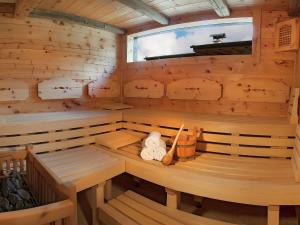 a wooden sauna with two benches and a window at Spacious Apartment with Sauna in F gen in Fügen