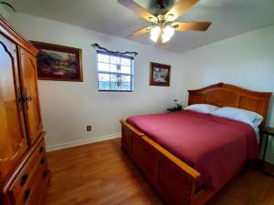 a bedroom with a bed and a ceiling fan at The Greenhouse - 3bed 2bath home in Tahlequah, OK in Tahlequah