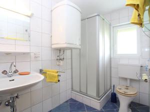 a white bathroom with a sink and a shower at Beautiful apartment in a renovated farmhouse in Fresach Carinthia in Fresach