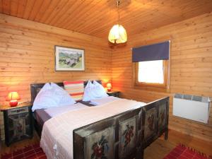 a bedroom with a bed in a wooden cabin at Beautiful apartment in a renovated farmhouse in Fresach Carinthia in Fresach
