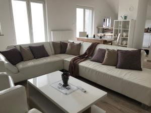 a living room with a couch and a table at Garden House in Kranj