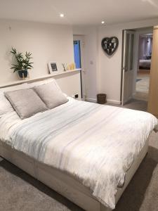 a bedroom with a large white bed in a room at High gables Apartment 1 in Paignton