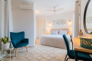 a bedroom with a bed and a table and chairs at Villa Leveque - Kassiopi Sea View - 3 bedrooms in Kassiopi +70 photos