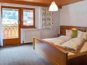 a bedroom with a bed and a window at Vintage holiday home near the ski bus stop in Längenfeld