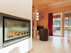 a fireplace in a living room with a fire place at Chalet in Styria near the ski area in Stadl an der Mur