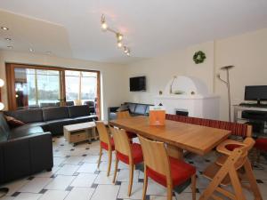 a living room with a wooden table and chairs at Lovely Chalet in Mayrhofen with Private Garden in Mayrhofen