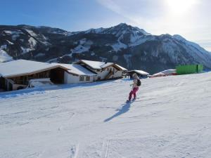 a person is skiing down a snow covered slope at Apartment in Kaprun near the ski area in Kaprun
