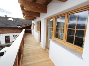 a corridor of a house with wooden floors and windows at Apartment in Kaprun near the ski area in Kaprun