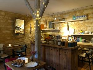 a restaurant with a counter with tables and chairs at La Tour de Cause in Castelnaud La Chapelle