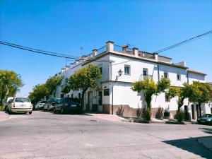 a white building on the side of a street at Jacaranda in Prado del Rey