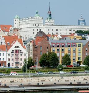 a city with a river and buildings and cars at Cocorico Bed and Breakfast OLD TOWN Szczecin Adults Only in Szczecin