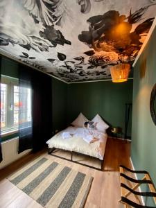 a bedroom with a bed with a painting on the ceiling at Schlafen über der Whiskybar in Rüdesheim am Rhein