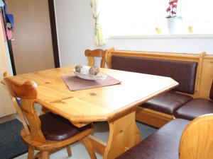 a wooden table with a bowl on top of it at Lovely Chalet in Maria Alm with Terrace in Maria Alm am Steinernen Meer