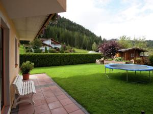 a patio with a table in the grass at Apartment in Altenmarkt in Pongau near ski area in Altenmarkt im Pongau