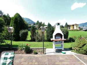 a backyard with a dog house in a yard at Apartment in Tirol with private garden in Kirchberg in Tirol