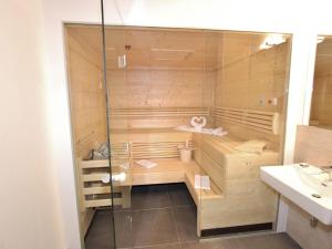 a bathroom with a sauna with a sink at Luxury Chalet in Saalbach Hinterglemm near Ski Area in Saalbach Hinterglemm