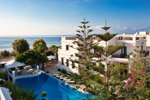 an aerial view of a hotel with a swimming pool and the ocean at Veggera Beach Hotel in Perissa