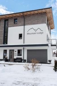 a building with a mountain lodge sign on it at Mountain Lodge in Galtür
